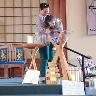 woman-holding-young-girl-baptismal_2025_09